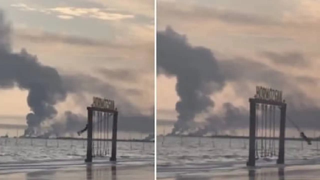 Iranian Girl Swings As Smoke Rises In Background After US and Israel Strike